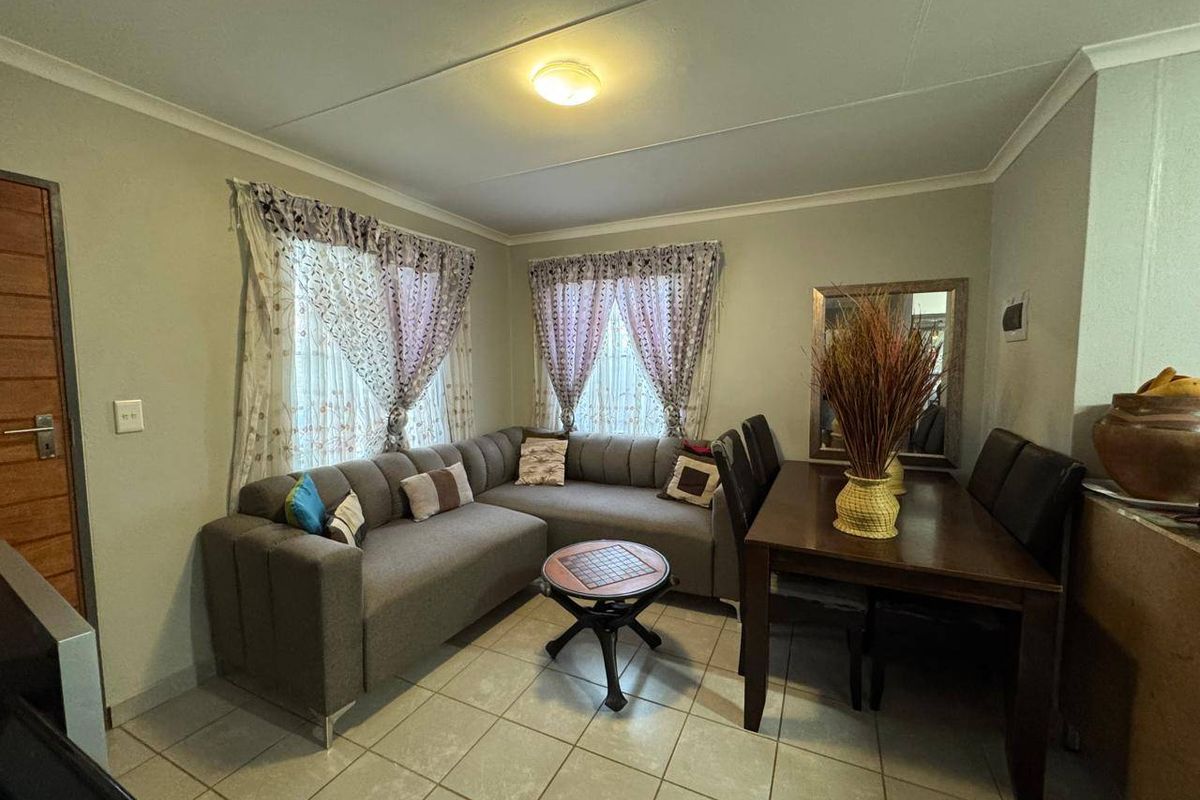A functional living area featuring tiled flooring, neutral wall finishes, and a flush mount ceiling light, providing a comfortable and practical space.