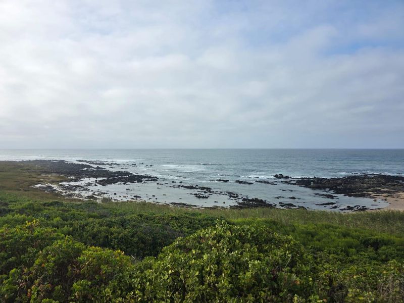 A scenic view of the rocky coastline and ocean, showcasing the natural landscape of the vacant residential property.