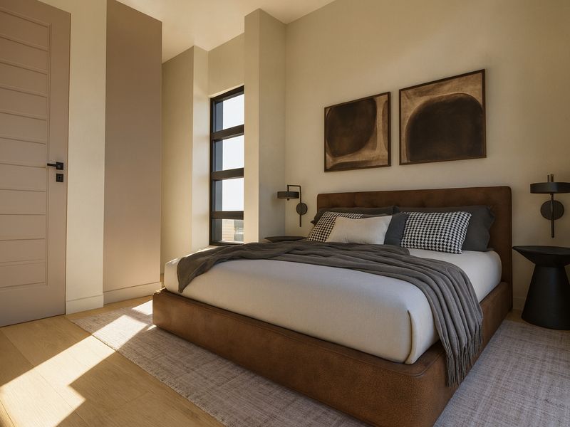 A modern, well-lit bedroom featuring hardwood flooring, neutral wall tones, and a contemporary window design.