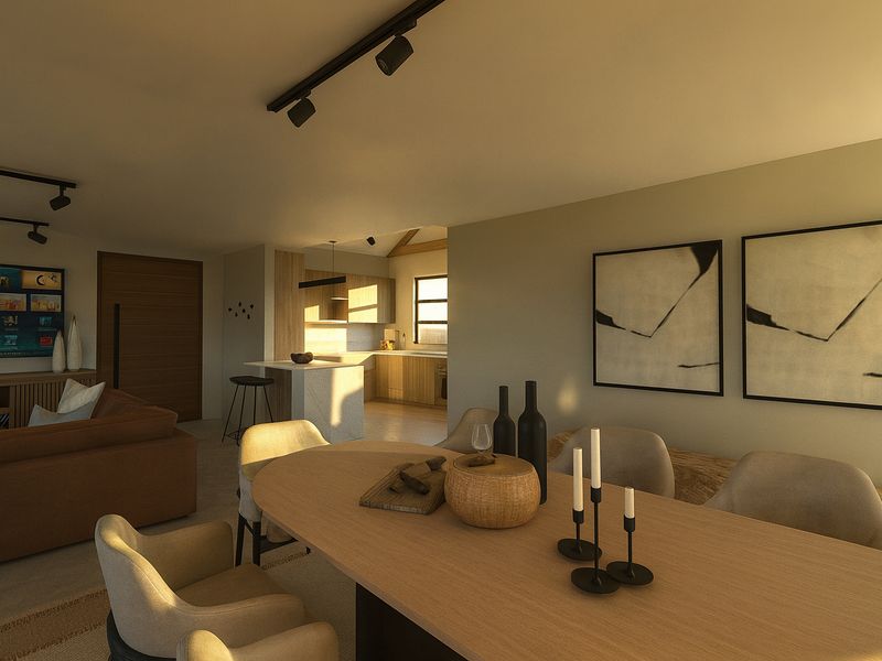 A modern open-plan living and dining area featuring track lighting, a central kitchen island, and warm timber accents throughout the space.