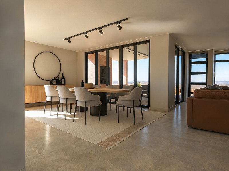 Spacious open-plan dining area featuring modern track lighting, large format floor tiles, and expansive black-framed sliding doors leading to an outdoor space.