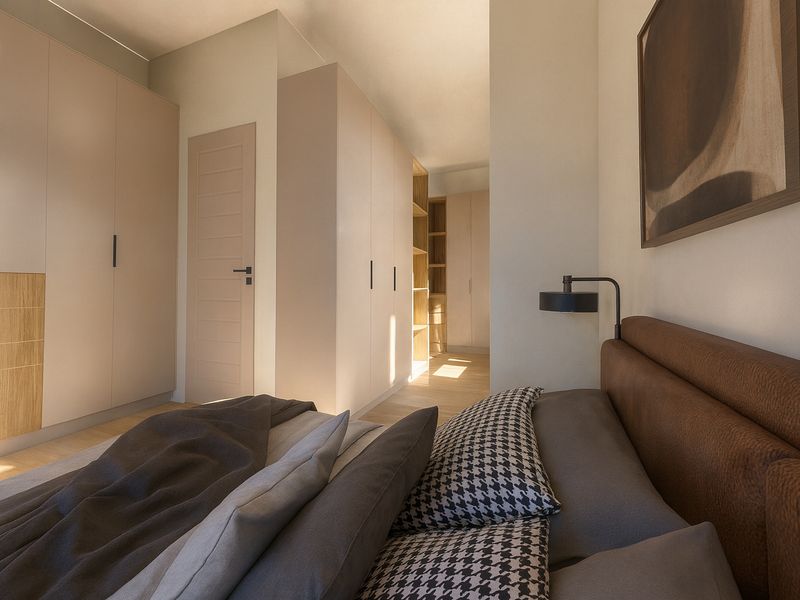 A modern, well-lit bedroom featuring extensive built-in cabinetry, light hardwood flooring, and a clean, contemporary aesthetic.