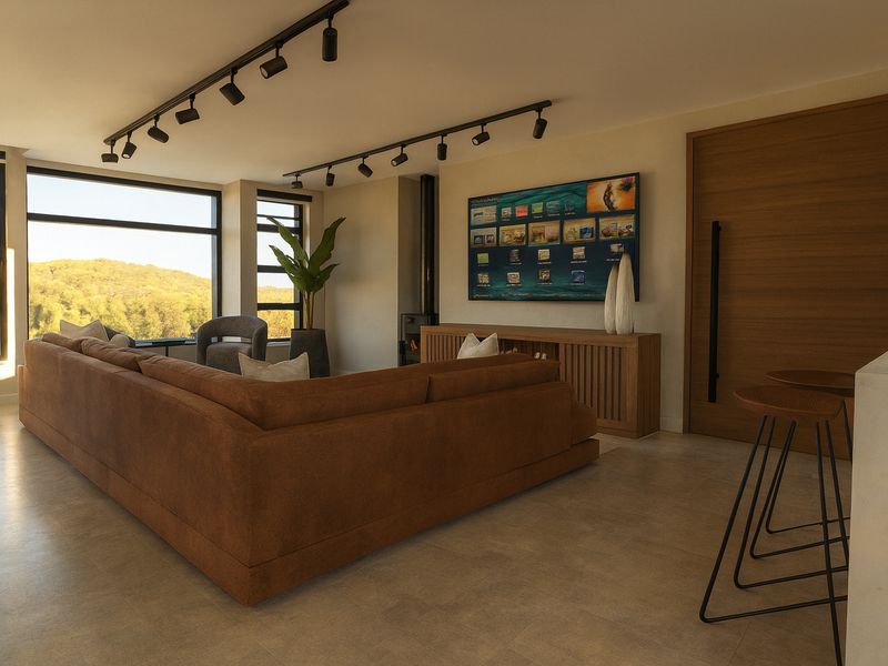 Modern open-plan living area featuring track lighting, large windows with scenic views, tiled floors, and a built-in fireplace.