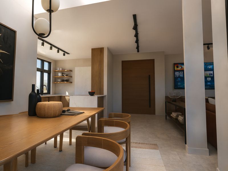 Modern open-plan living and dining area featuring high-quality finishes, contemporary track lighting, and a sleek kitchen with stone island.