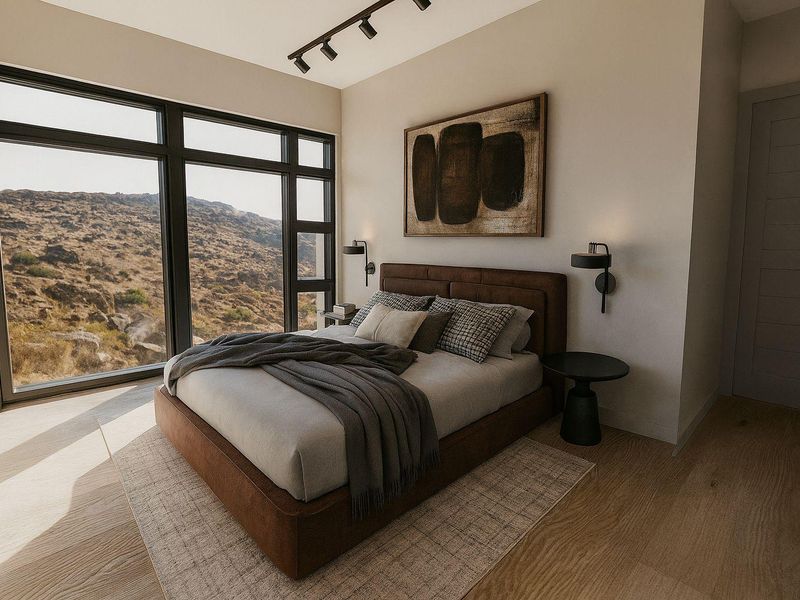 Modern bedroom featuring large floor-to-ceiling windows with scenic mountain views, track lighting, and high-quality hardwood flooring.
