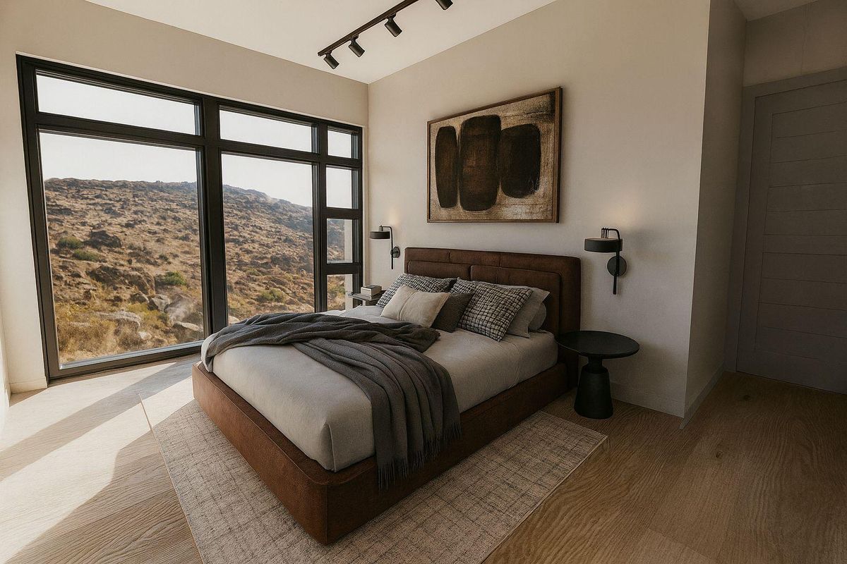 Modern bedroom featuring large floor-to-ceiling windows with scenic mountain views, track lighting, and high-quality hardwood flooring.