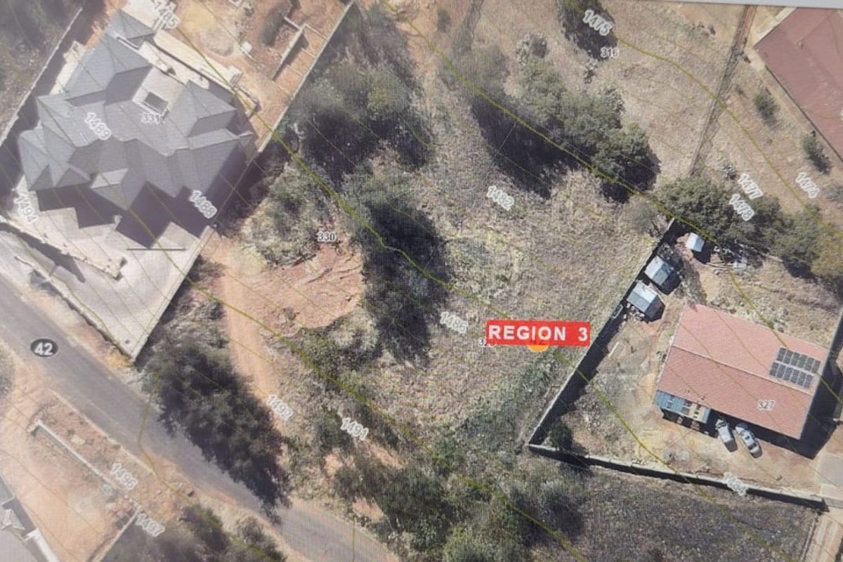 An aerial view of a vacant residential plot featuring topographical contour lines and boundary markers, situated within an established neighborhood.