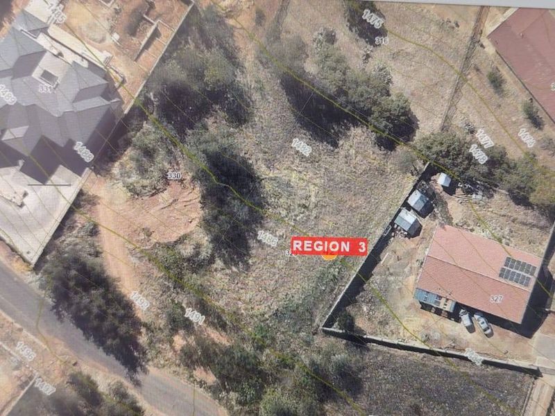 An aerial view of a vacant residential plot showing topographical contours, boundary lines, and surrounding properties.