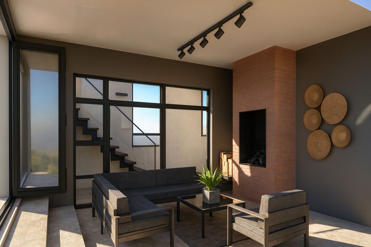 Modern living room featuring a prominent brick fireplace, track lighting, and large windows with an adjacent staircase, creating a bright and contemporary atmosphere.
