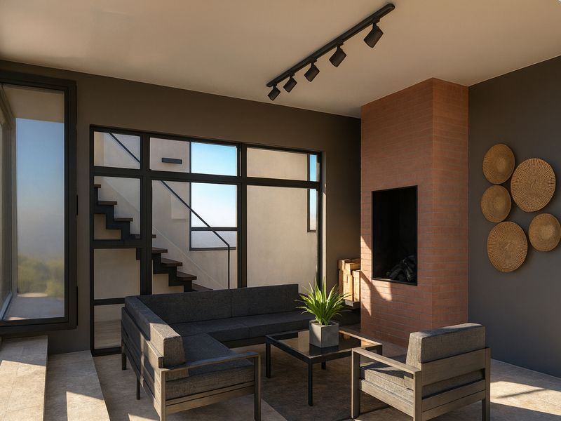 Modern living room featuring a prominent brick fireplace, track lighting, and large windows with an adjacent staircase, creating a bright and contemporary atmosphere.