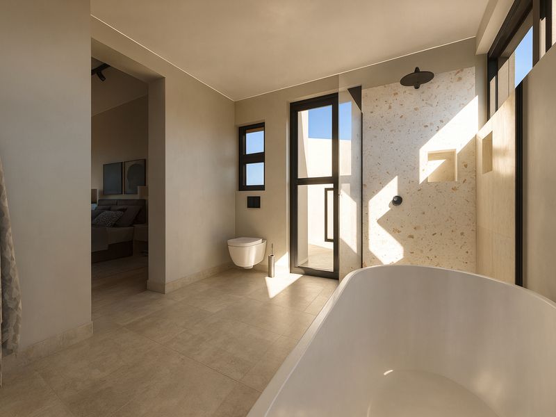 Modern bathroom featuring a freestanding bathtub, wall-mounted toilet, and a stylish terrazzo-tiled shower area with built-in niche and black fixtures.