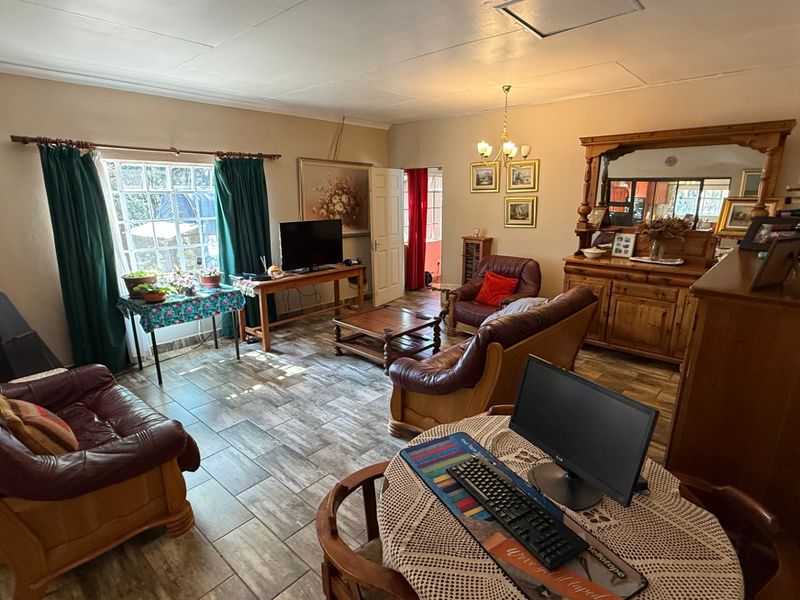 A spacious living room featuring tiled flooring and a freestanding fireplace, offering a comfortable and functional layout for relaxation.
