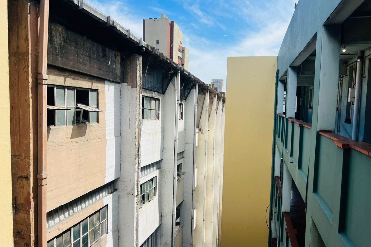 Exterior view of the apartment building facade showing multi-story residential structure with visible wear and aging on the exterior finishes.