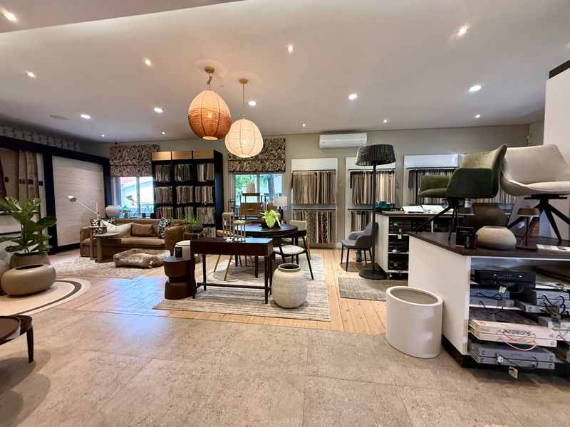 Spacious open-plan living area featuring a mix of tiled and timber flooring, recessed lighting, and a wall-mounted split-system air conditioner.