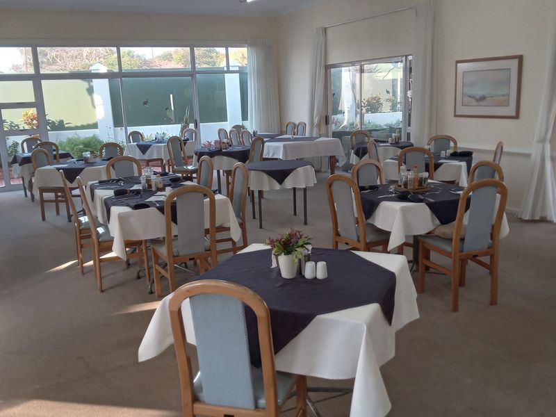 A spacious dining area featuring large sliding glass doors that provide natural light and access to the outdoor patio area.
