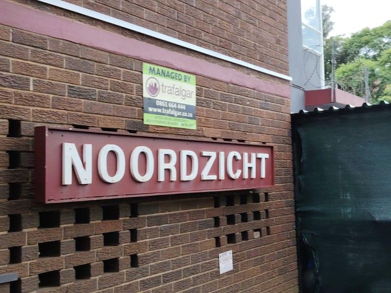 Exterior view of the Noordzicht apartment complex entrance featuring a face brick facade and building signage.