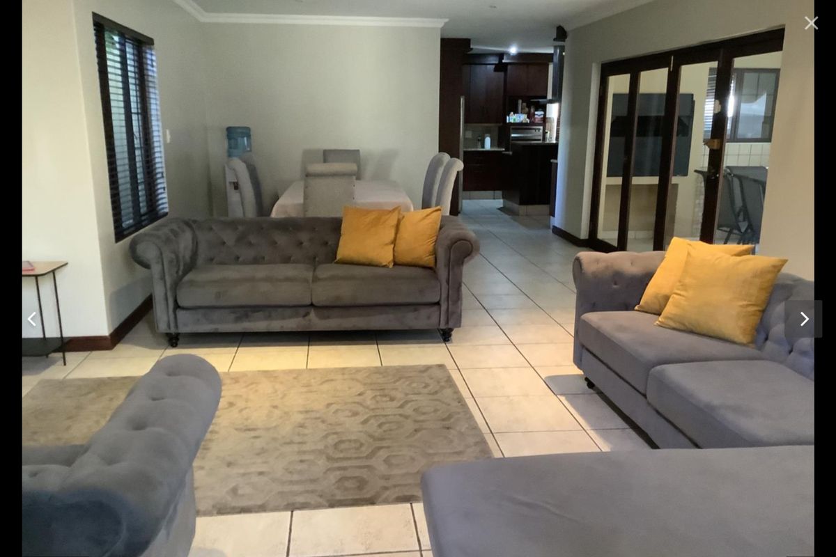 Open plan living and dining area featuring tiled floors, recessed lighting, and direct access to an outdoor patio through sliding glass doors.