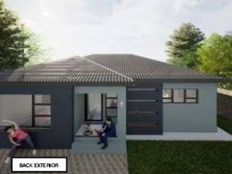 A rear exterior view of a modern single-story house featuring a tiled roof, paved patio area, and contemporary dark grey facade finishes.