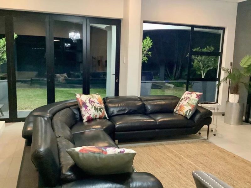 Spacious living room featuring large glass sliding doors that provide seamless access to the outdoor area and ample natural light.
