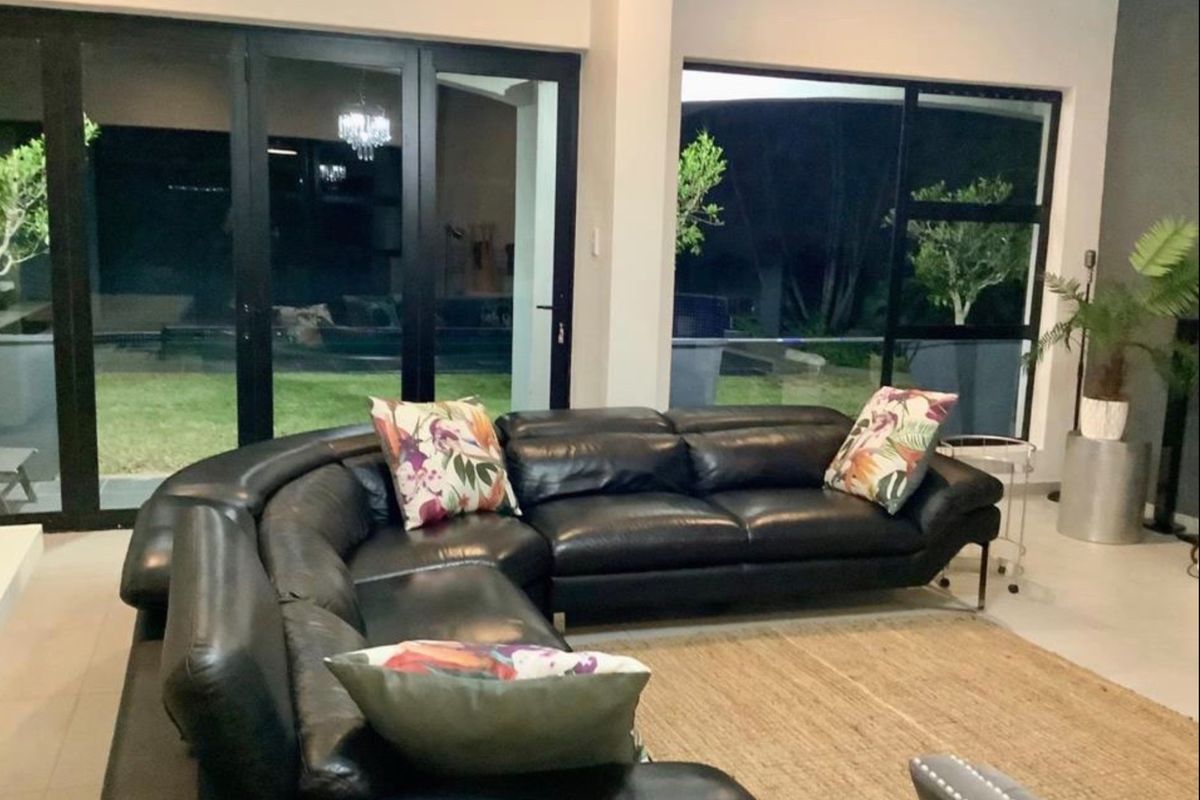 Spacious living room featuring large glass sliding doors that provide seamless access to the outdoor area and ample natural light.