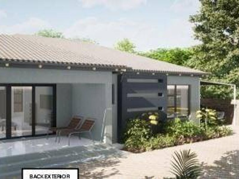 A modern rear exterior view featuring a covered tiled patio, sliding glass doors, and a well-maintained paved area with landscaped garden beds.