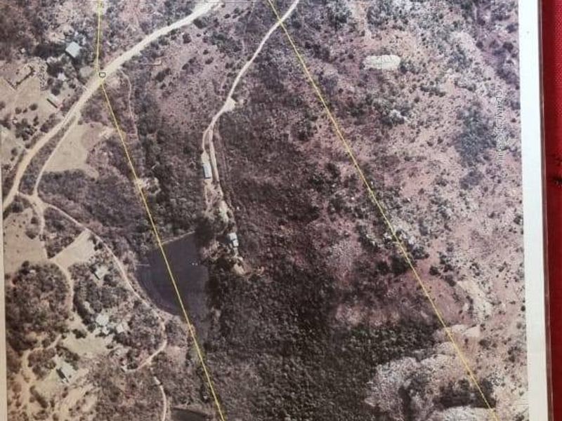 An aerial view of the farm property showing the land boundaries, access roads, and a water reservoir on the site.