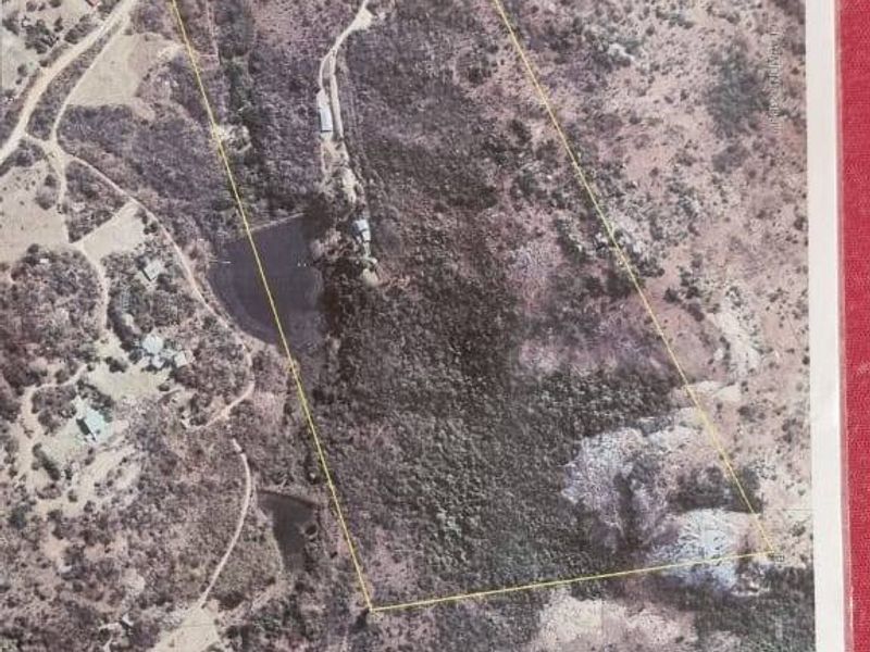 An aerial view of the farm property showing the land boundaries, access roads, and existing water dam infrastructure.