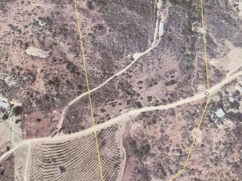 Aerial view of the farm property showing the land boundaries, access road, and existing dam infrastructure.
