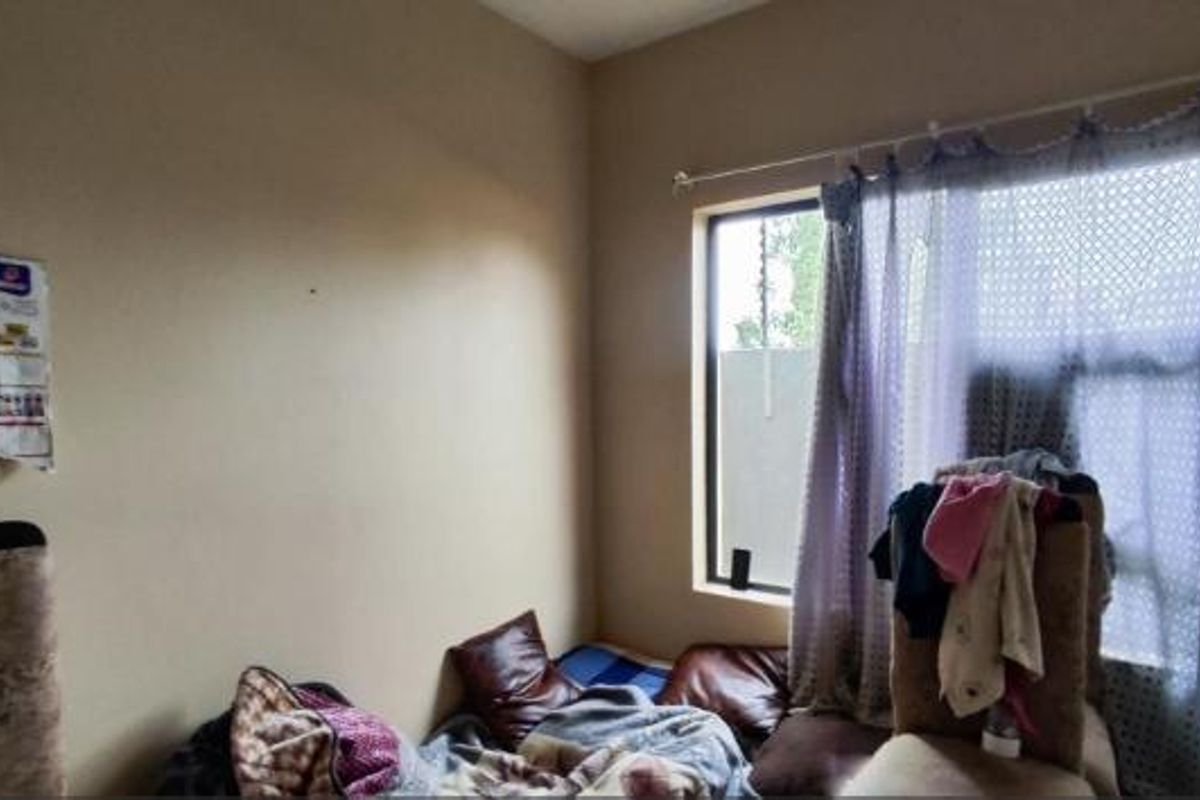 A bedroom featuring a window with a curtain rod, requiring cosmetic updates to improve the overall aesthetic and appeal.