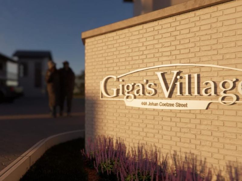 Entrance signage for Giga's Village located at 44A Johan Coetzee Street, featuring a modern brick boundary wall and paved driveway access.