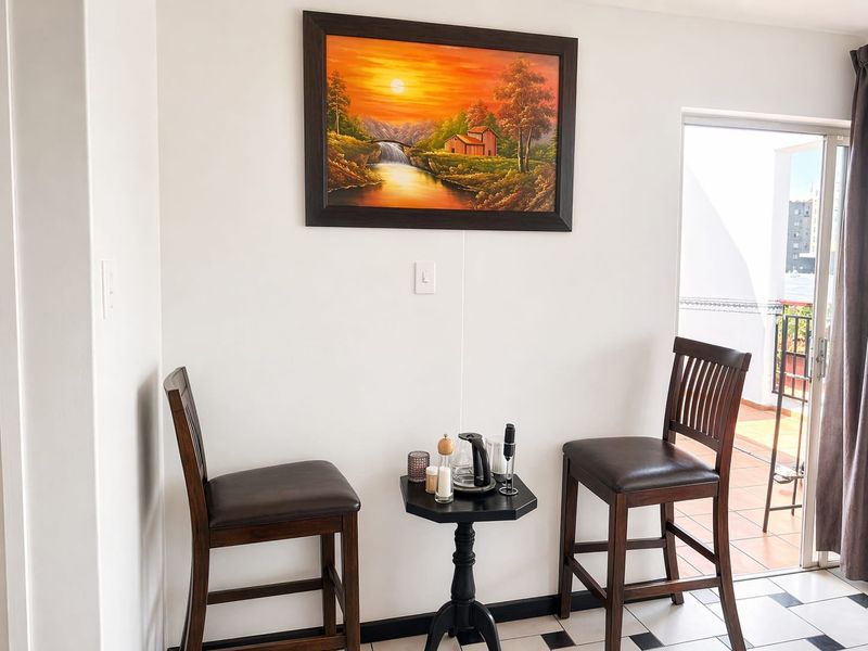 A bright corner area featuring tiled flooring and sliding glass door access to an outdoor balcony space.