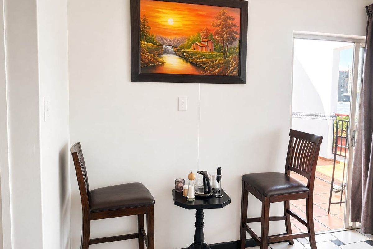 A bright corner area featuring tiled flooring and sliding glass door access to an outdoor balcony space.