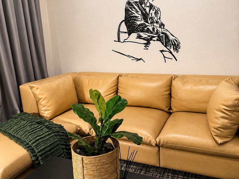 A well-maintained living room area featuring neutral wall finishes and integrated curtain tracks.