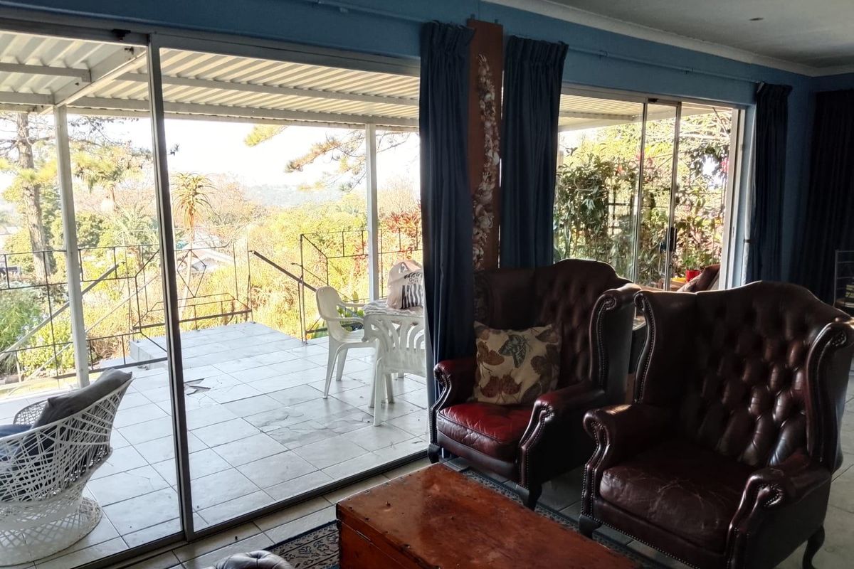 A living room featuring large sliding glass doors that provide access to an outdoor patio area and natural light.
