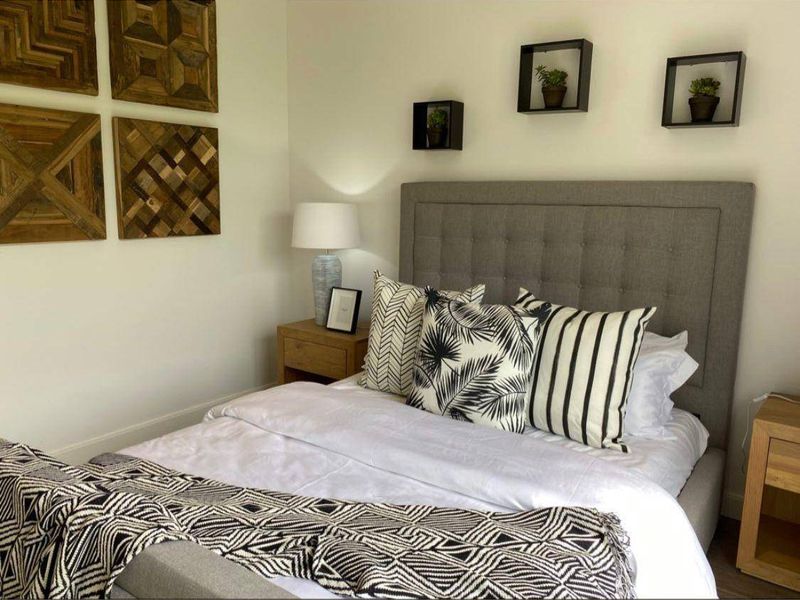 A well-presented bedroom featuring neutral wall finishes and a modern aesthetic.