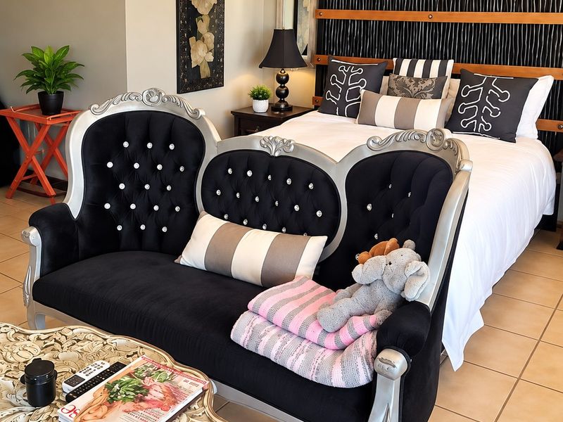 A well-maintained bedroom featuring tiled flooring, a split-system air conditioner, and a decorative built-in headboard.