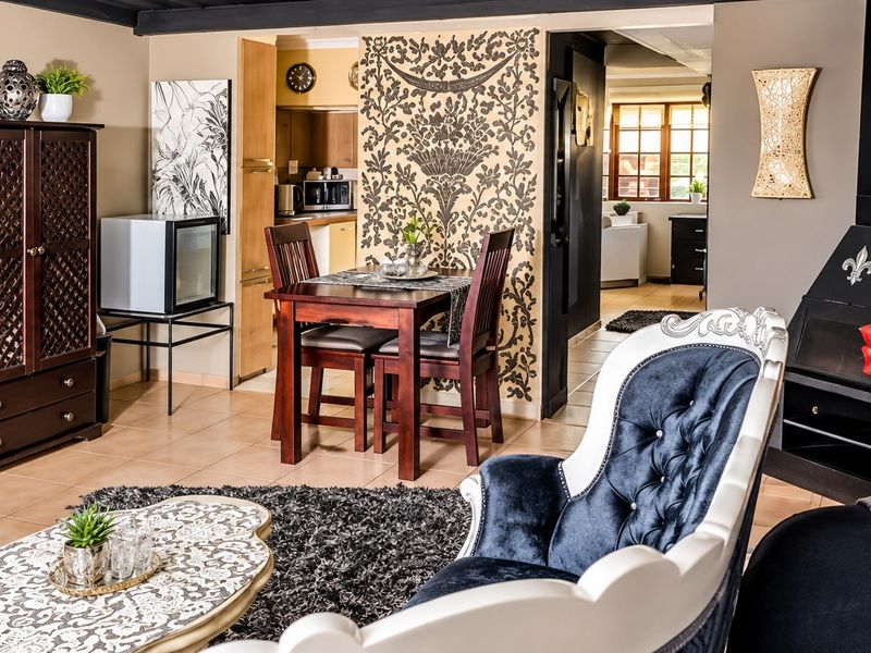 Open plan living and dining area featuring tiled floors, a built-in fireplace, and direct access to the kitchen and adjacent rooms.