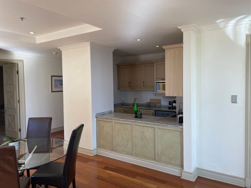 Open plan kitchen area featuring granite countertops, built-in cabinetry, and hardwood flooring, seamlessly integrated with the adjacent dining space.