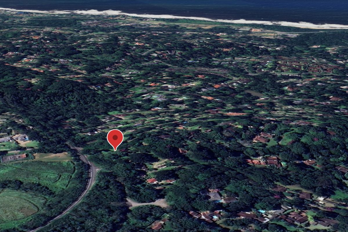 An aerial satellite view of a residential neighborhood with a map pin indicating the property location.