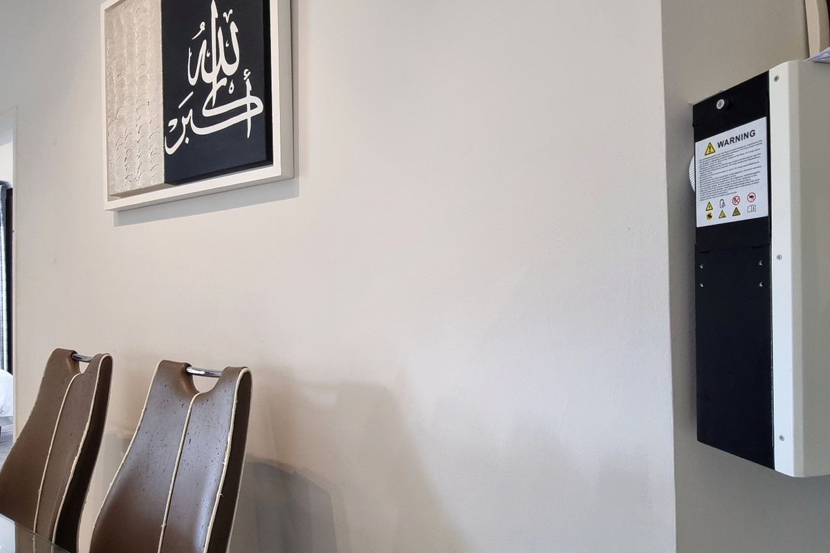 Interior view featuring a wall-mounted solar inverter system installed in a residential living space.