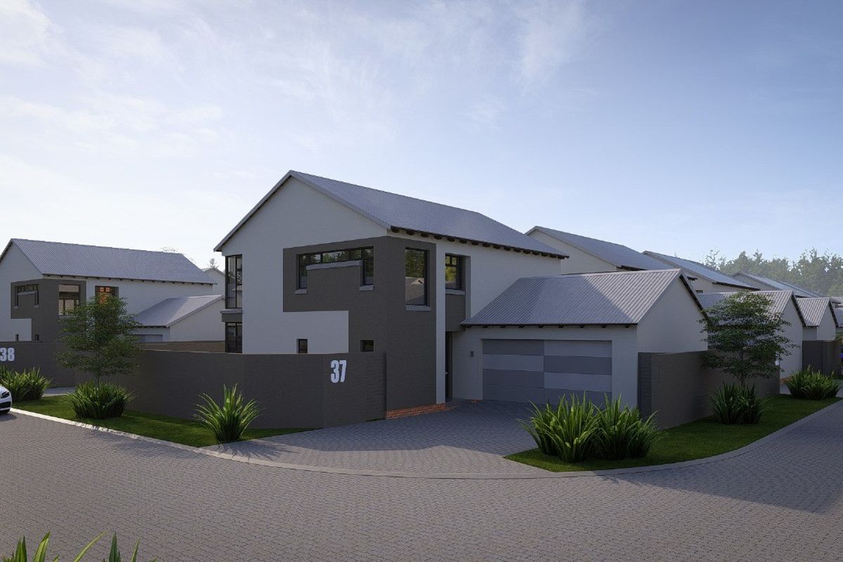 A modern residential house exterior featuring a paved driveway, attached garage, and contemporary architectural design within a suburban estate setting.