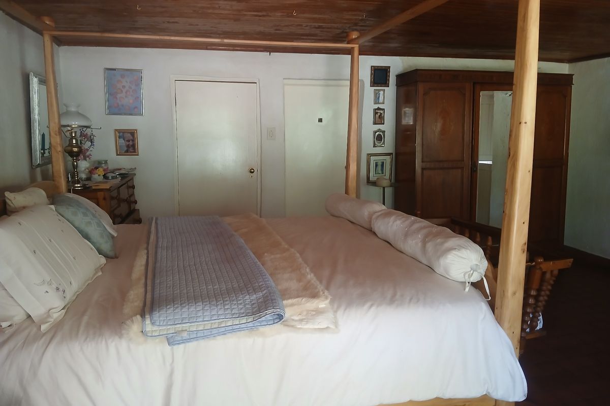A bedroom featuring a timber ceiling and built-in wardrobe storage.