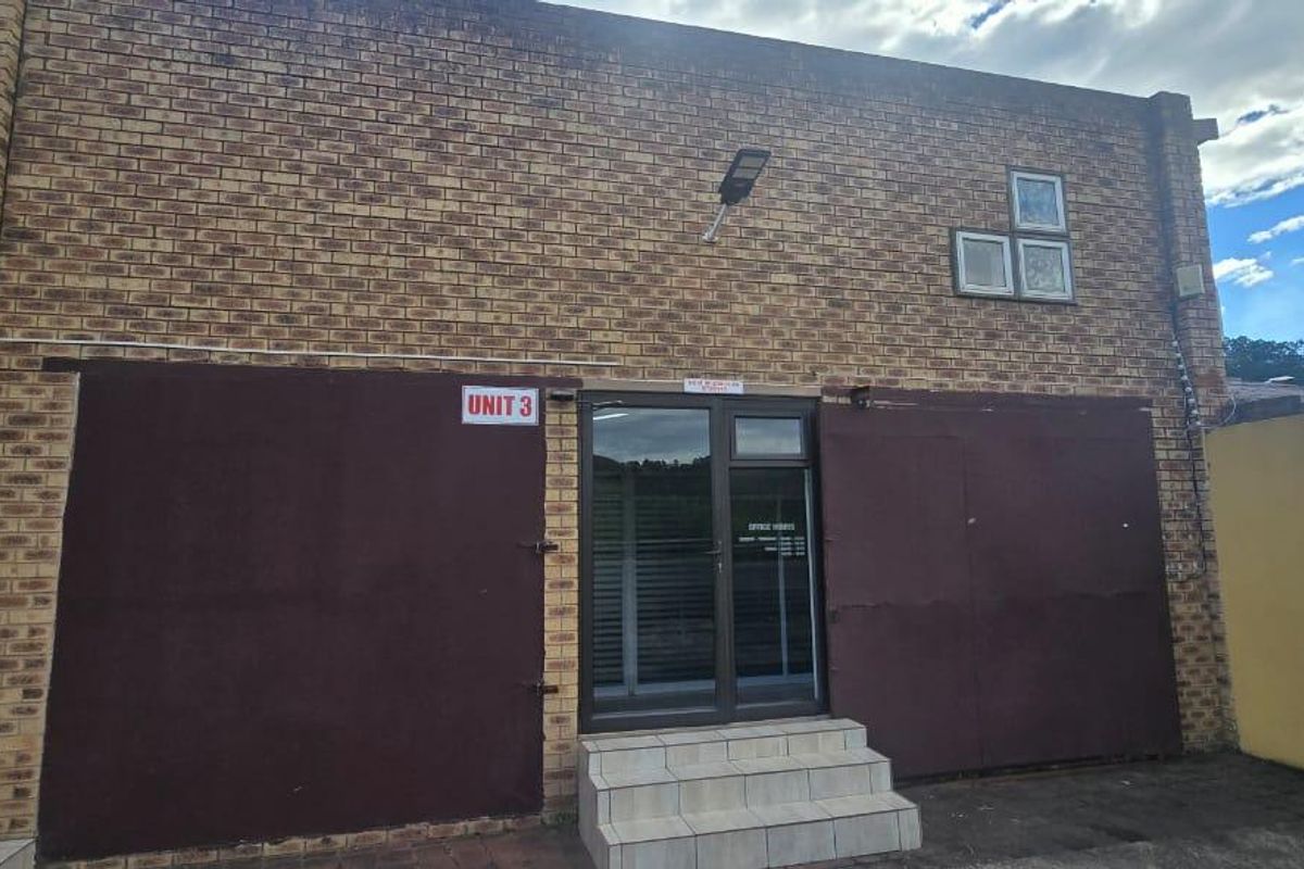 Front exterior view of commercial Unit 3, featuring a face brick facade, secure metal shutters, and an aluminium glass entrance door with tiled steps.
