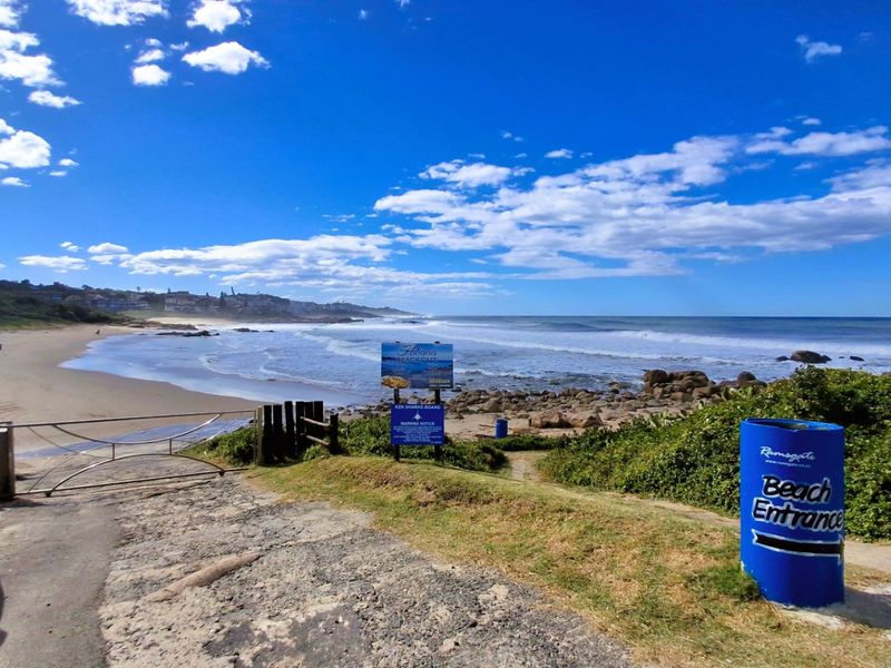 A scenic view of the coastline and beach entrance, showcasing the natural beauty and proximity to the ocean.