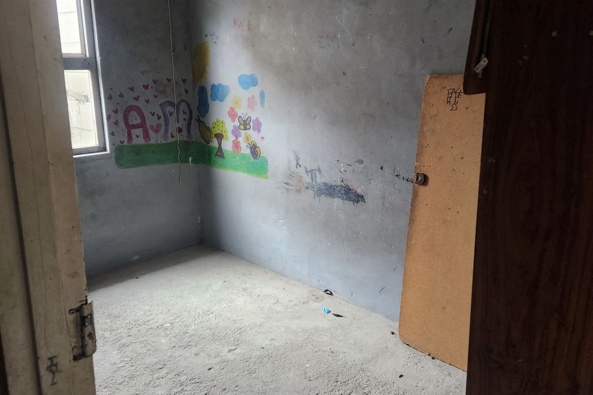 A vacant bedroom featuring unfinished concrete flooring and walls requiring cosmetic repair and repainting.