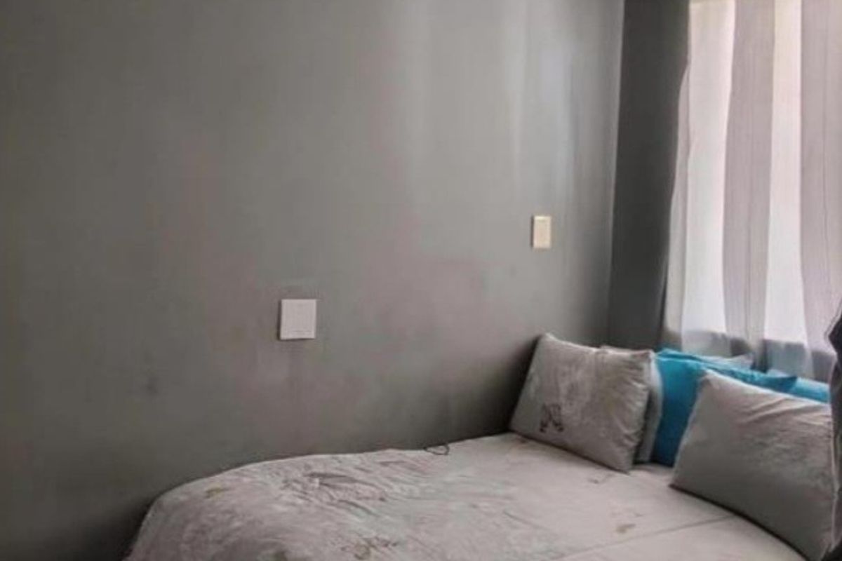 A compact bedroom featuring grey painted walls, a ceiling light fixture, and coving detail.