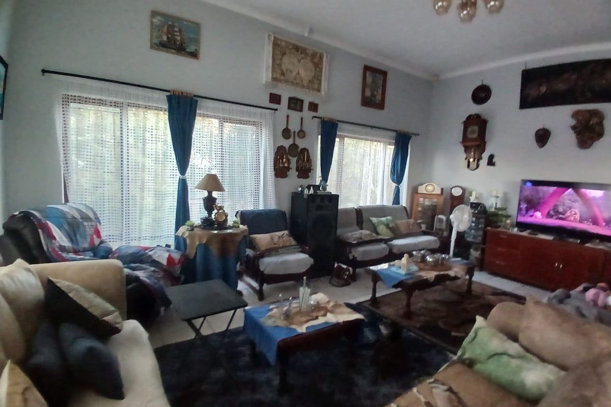 A spacious living room featuring large sliding glass doors that provide natural light and access to the outdoors.
