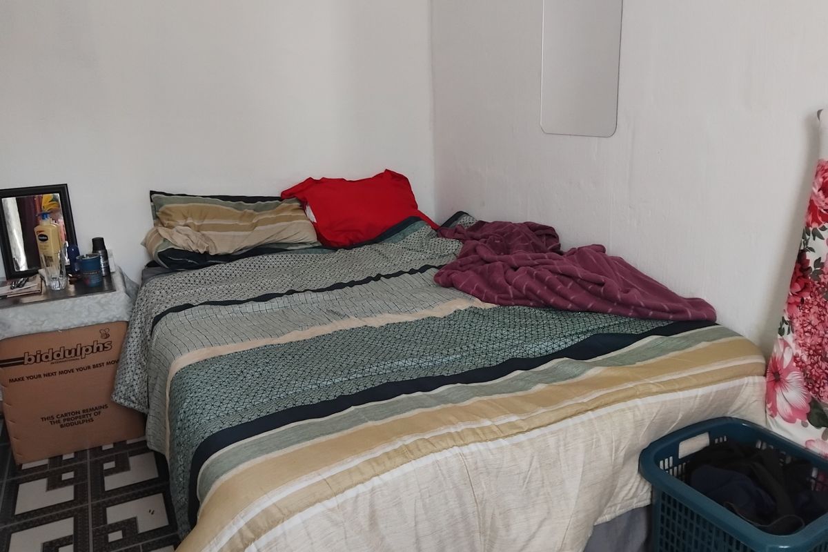 A compact bedroom space featuring basic finishes, suitable for a single or double bed configuration.