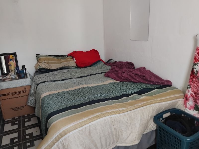 A compact bedroom space featuring basic finishes, suitable for a single or double bed configuration.