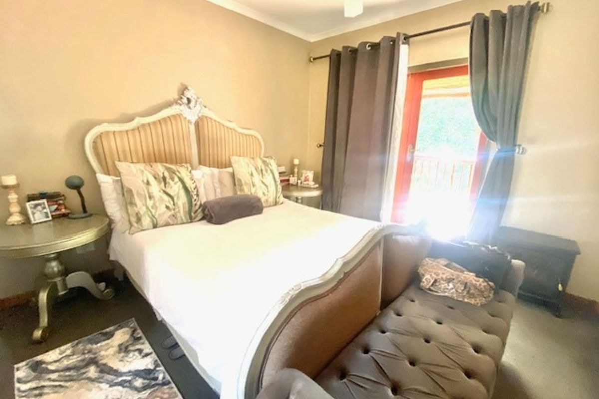 A bedroom featuring a ceiling fan and a sliding glass door providing access to the exterior.